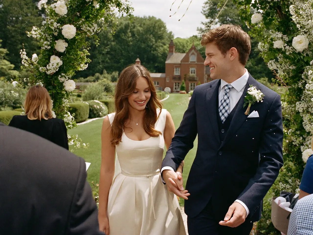 The vows under the flower arch in the manor garden