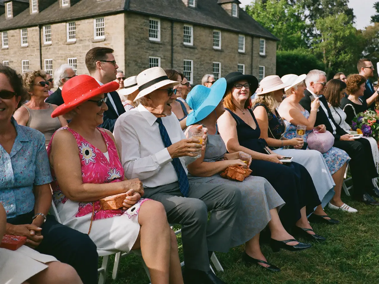 Elderly guests laughing together at the garden ceremony