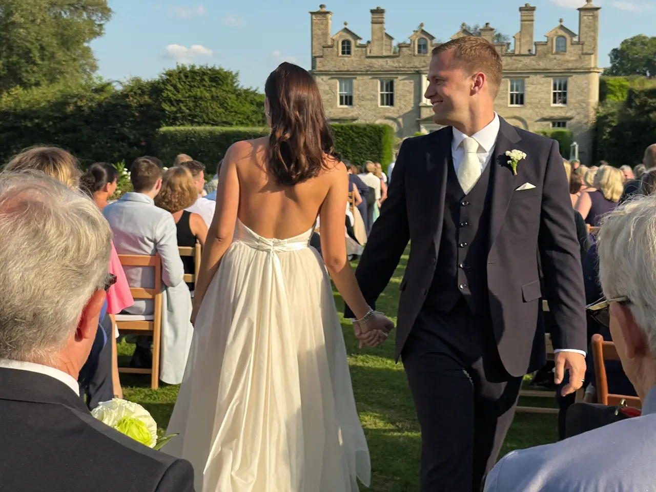 The vows at the garden ceremony, seen over the guests