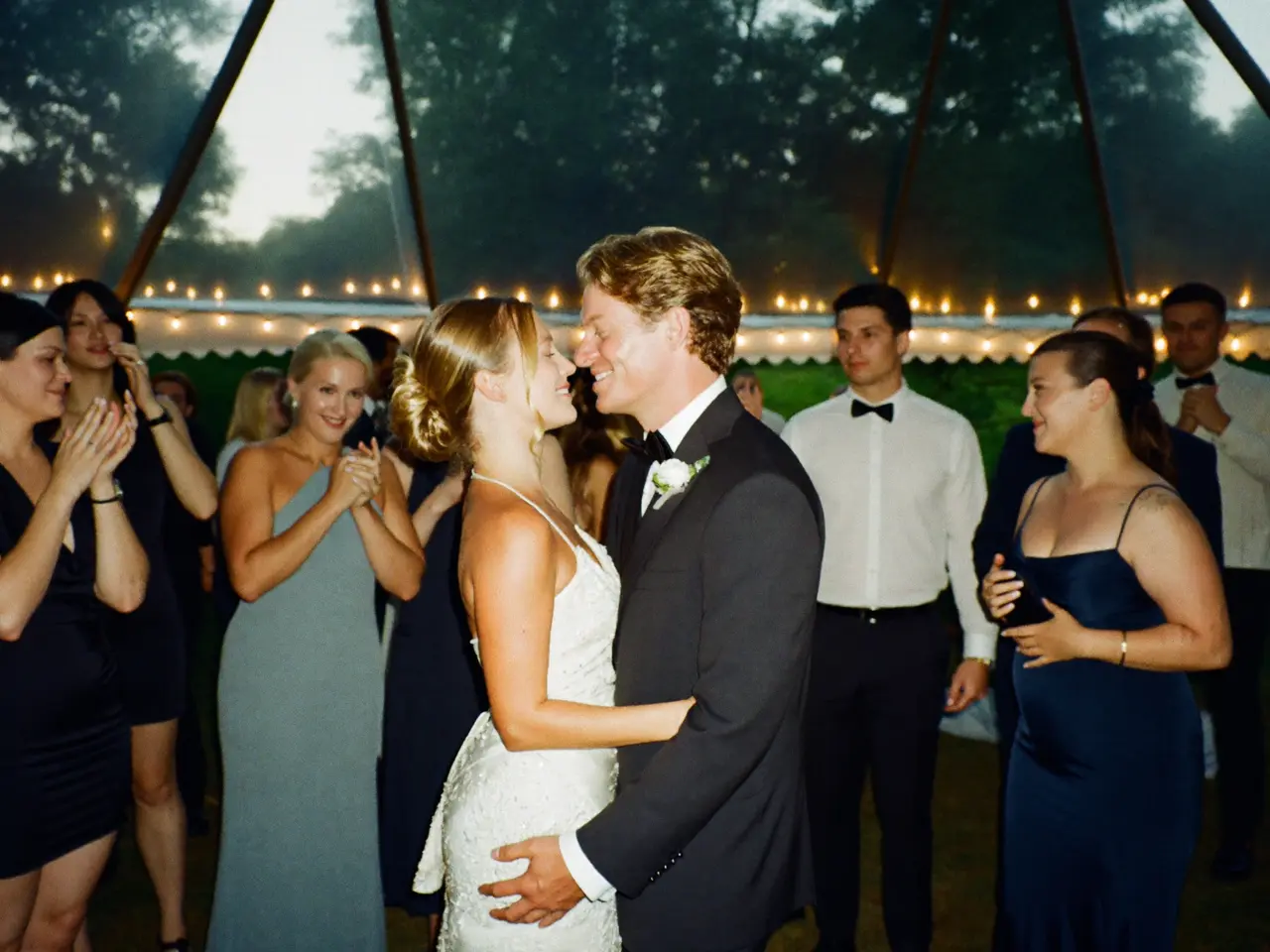 Guests at a British wedding adding reception photographs to a shared digital album
